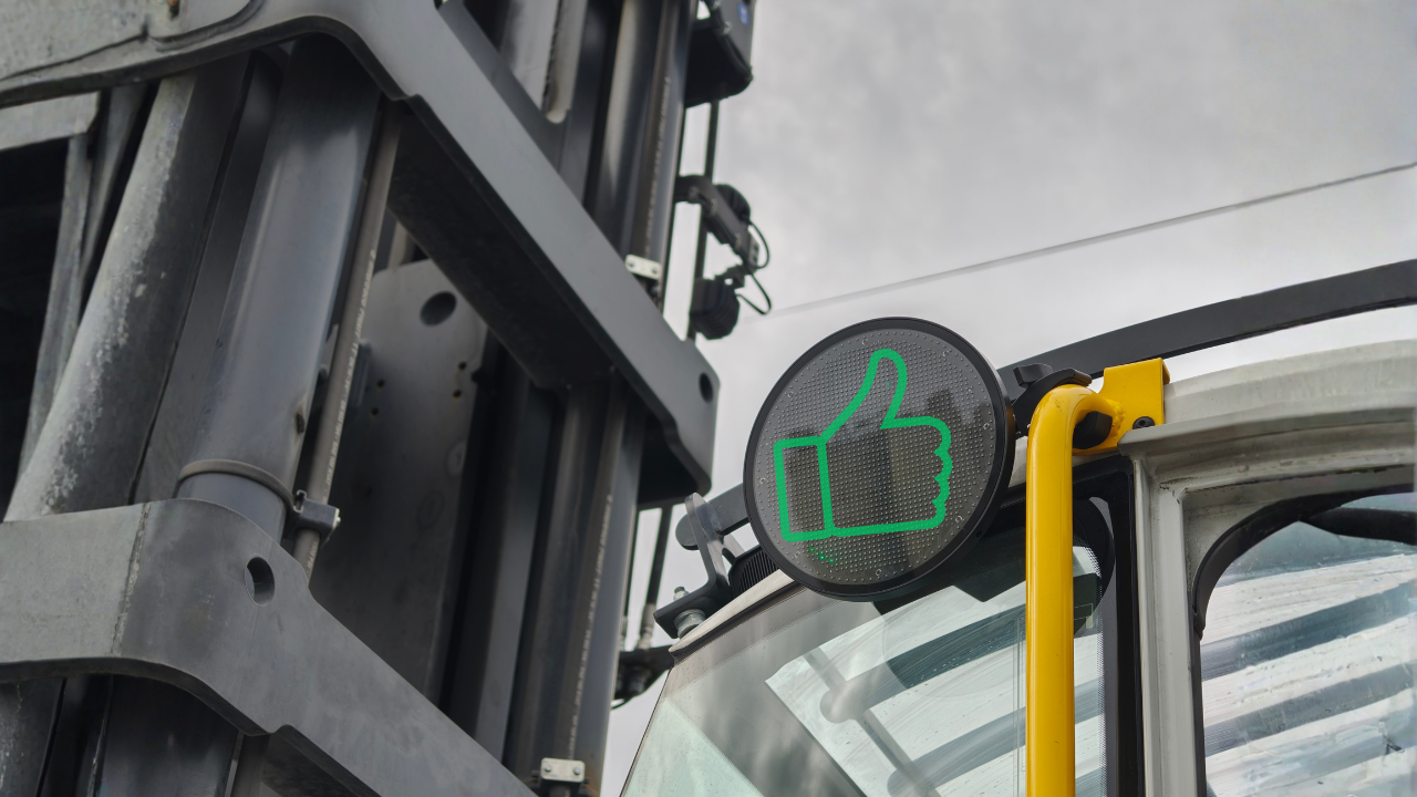 an add-on to Site Safety system, thumbs up safe-approach system showing green icon when machine disabled as